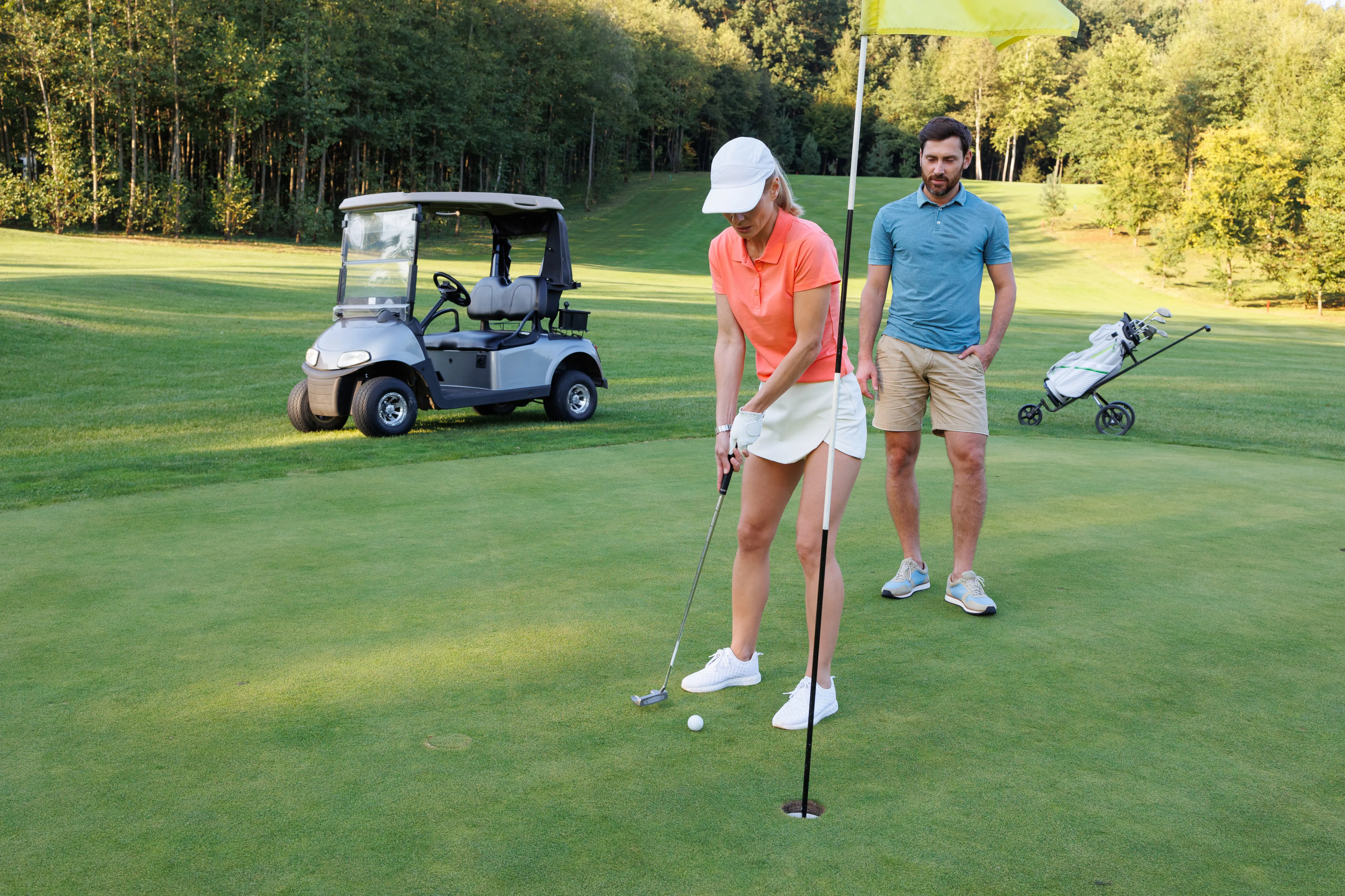 A couple in love enjoying golf on the fairway.